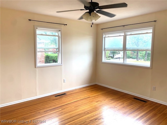 spare room with light hardwood / wood-style flooring and ceiling fan