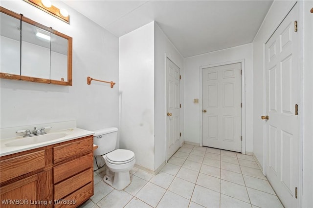 bathroom with tile patterned floors, vanity, and toilet