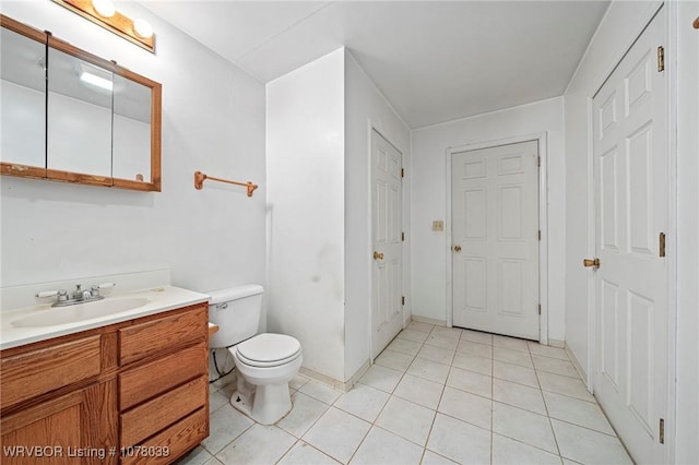 469517 E 1060th Rd, Muldrow, OK 74948 - bathroom featuring vanity, baseboards, tile patterned floors, and toilet