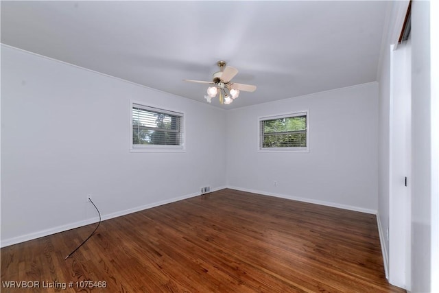 unfurnished room with ceiling fan, dark hardwood / wood-style flooring, and a healthy amount of sunlight