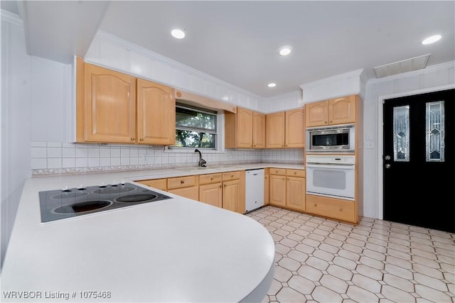 kitchen featuring stainless steel microwave, dishwasher, light brown cabinets, crown molding, and electric stovetop