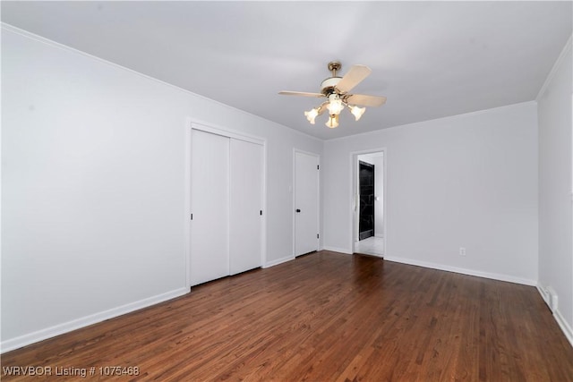 unfurnished bedroom with ceiling fan, dark wood-type flooring, and a closet