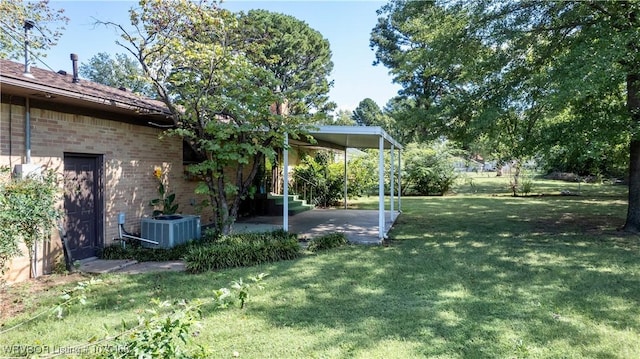 view of yard featuring central air condition unit and a patio