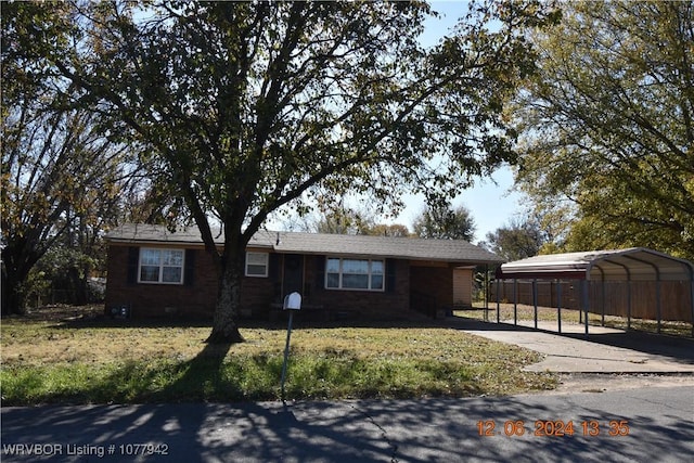 single story home featuring a carport and a front yard