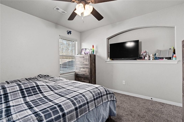 carpeted bedroom with visible vents, baseboards, and a ceiling fan