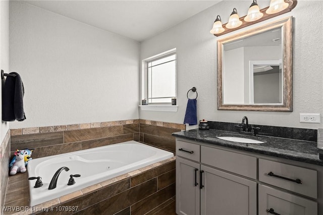 full bath with a jetted tub and vanity