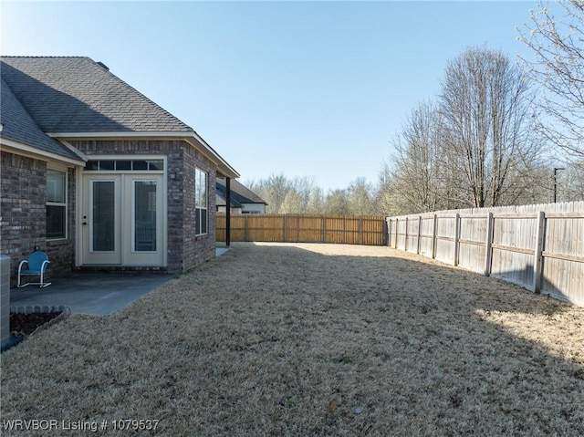 view of yard featuring a patio and a fenced backyard