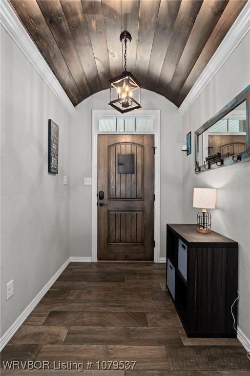 entrance foyer featuring baseboards, lofted ceiling, dark wood-style flooring, wood ceiling, and a notable chandelier