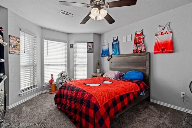 bedroom featuring visible vents, baseboards, carpet, and a ceiling fan