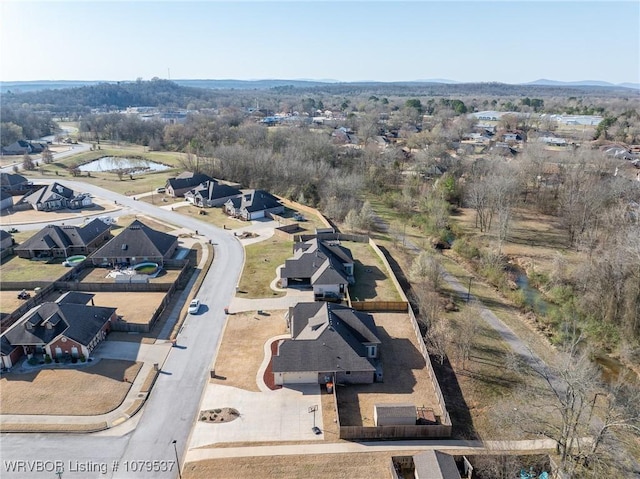 birds eye view of property with a residential view and a water view