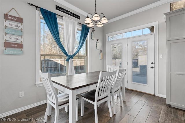 dining area featuring a chandelier, baseboards, wood finish floors, and ornamental molding