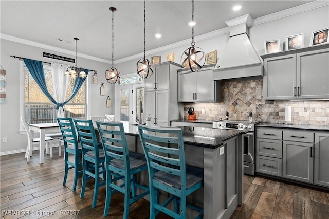 kitchen with premium range hood, a center island, gray cabinets, and electric stove