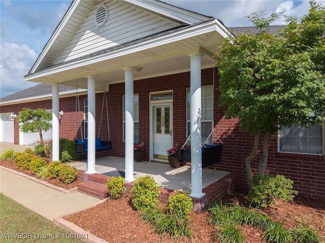 1318 Taos Dr, Van Buren, AR 72956 - view of front of home with a porch, brick siding, and an attached garage