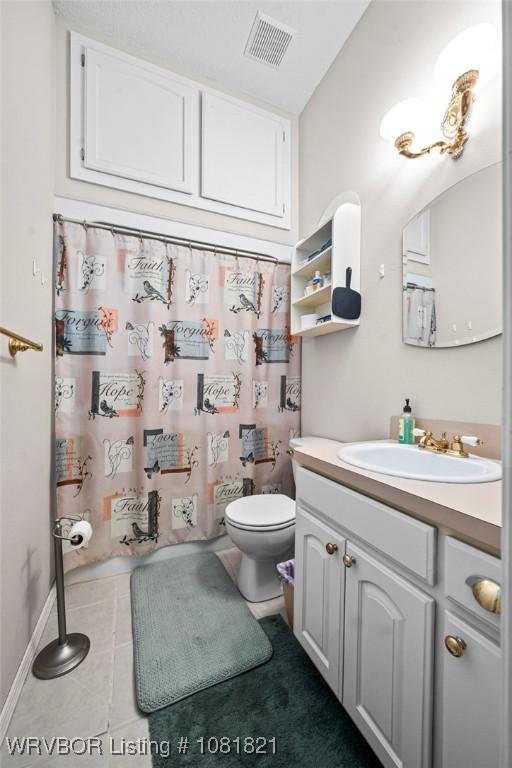 1318 Taos Dr, Van Buren, AR 72956 - full bathroom with vanity, tile patterned floors, and a shower with curtain