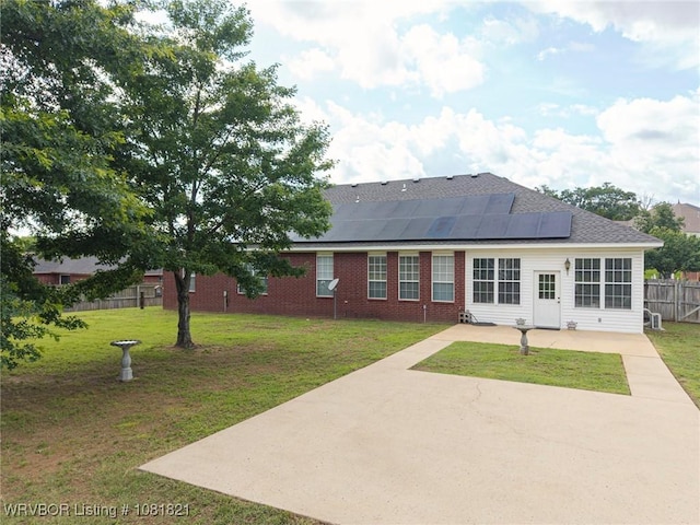 1318 Taos Dr, Van Buren, AR 72956 - back of house with solar panels, a patio, brick siding, and roof with shingles