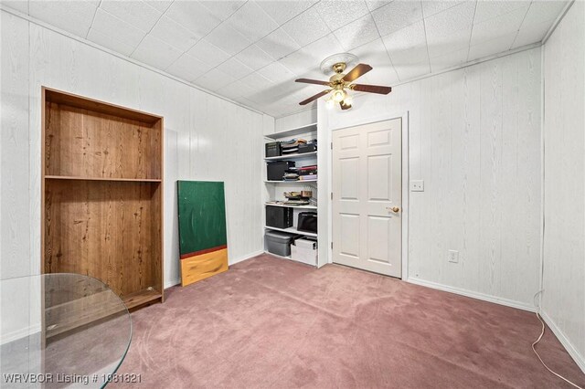 1318 Taos Dr, Van Buren, AR 72956 - unfurnished bedroom with carpet flooring, wooden walls, and a ceiling fan