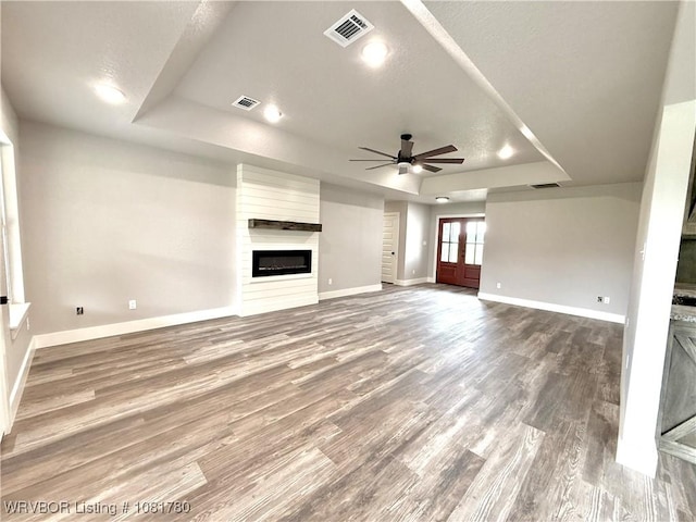2948 N Hwy 282, Van Buren, AR 72956 - unfurnished living room with a raised ceiling, a large fireplace, a ceiling fan, wood finished floors, and recessed lighting