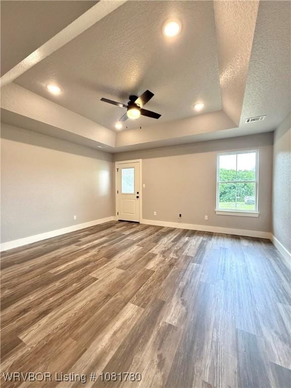 2948 N Hwy 282, Van Buren, AR 72956 - unfurnished room featuring a raised ceiling, a textured ceiling, wood finished floors, a ceiling fan, and recessed lighting