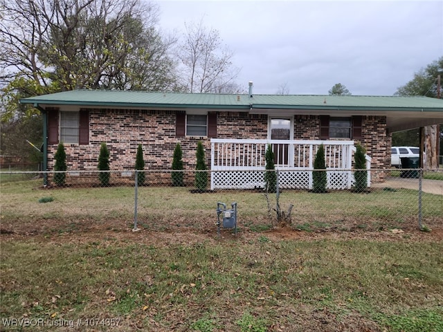 view of front of house featuring a front yard and a carport