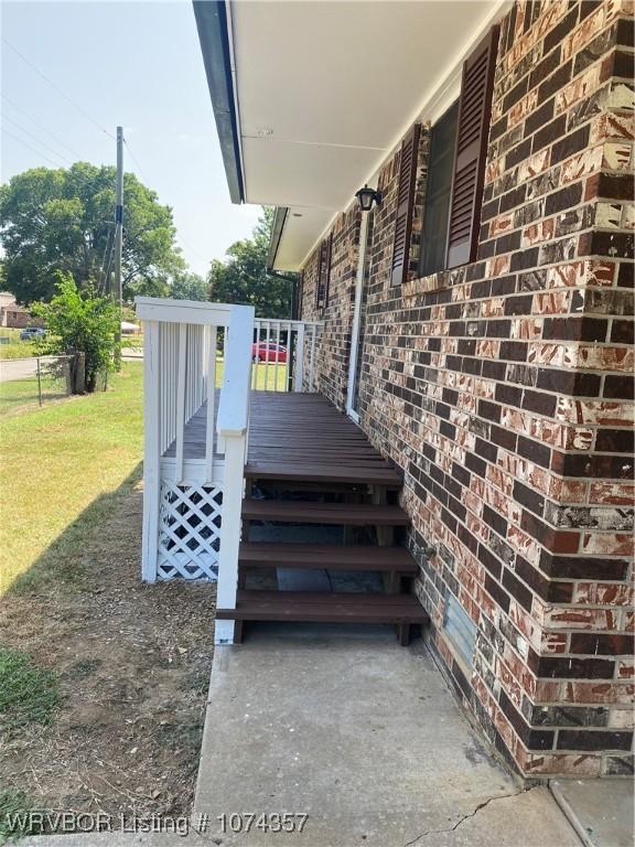 wooden terrace with a lawn