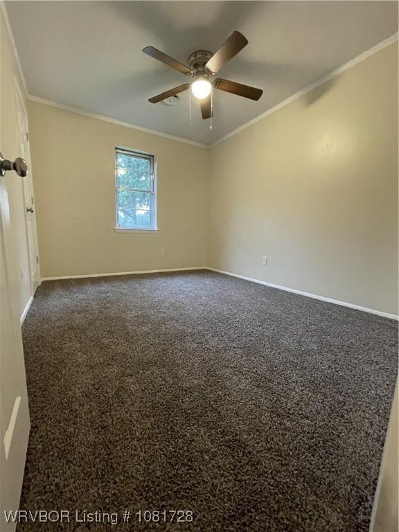 123 Gamma Cir, Roland, OK 74954 - spare room with ceiling fan, crown molding, and dark colored carpet