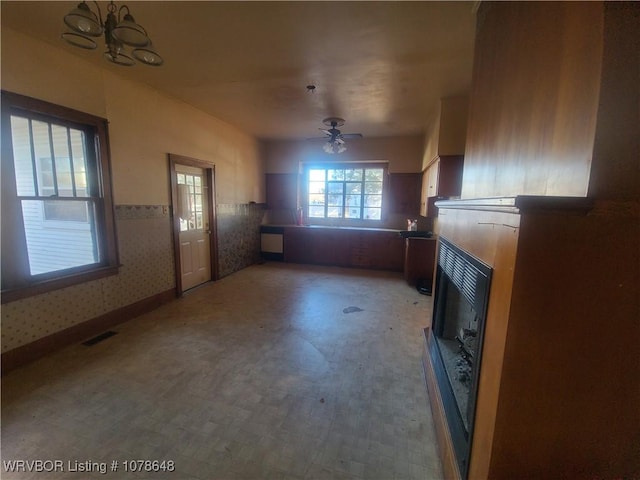 unfurnished living room featuring ceiling fan