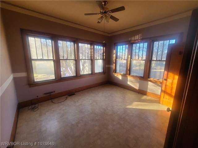 unfurnished sunroom with ceiling fan