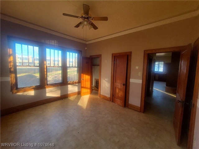 interior space with crown molding, vaulted ceiling, and ceiling fan