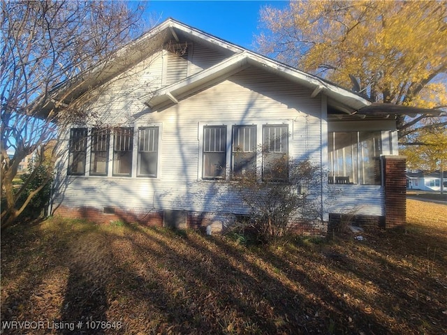 view of side of property featuring a sunroom