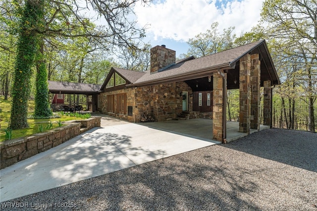 517 Ross Hampton Rd, Hackett, AR 72937 - view of front of house with a patio area, stone siding, driveway, and a chimney
