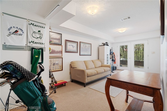 517 Ross Hampton Rd, Hackett, AR 72937 - carpeted living area with a textured ceiling, french doors, baseboards, and visible vents