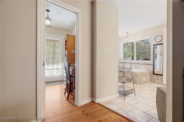 517 Ross Hampton Rd, Hackett, AR 72937 - hall with a notable chandelier and baseboards