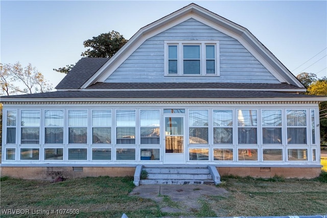 view of home's exterior with a sunroom