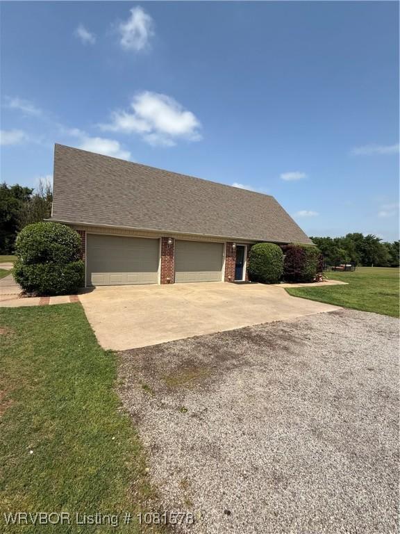 417 N Rattlesnake Rd, Charleston, AR 72933 - view of front of property featuring concrete driveway, a front yard, a garage, and brick siding