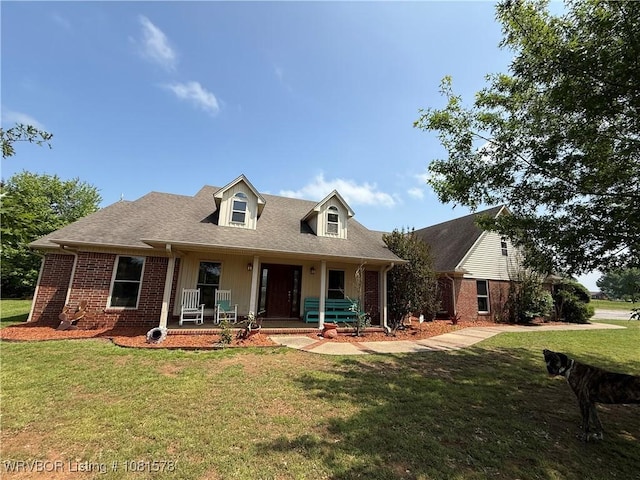 417 N Rattlesnake Rd, Charleston, AR 72933 - view of front of house with brick siding, covered porch, a front yard, and roof with shingles