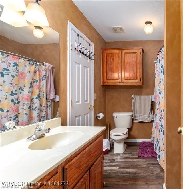 108 Wilson Ave, Poteau, OK 74953 - full bath with wood finished floors, vanity, toilet, a shower with curtain, and baseboards
