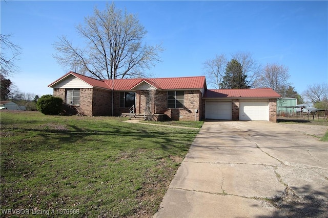ranch-style house featuring brick siding, a front yard, metal roof, a garage, and driveway