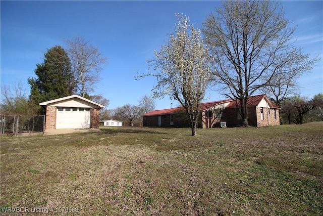 view of yard with a garage and an outdoor structure