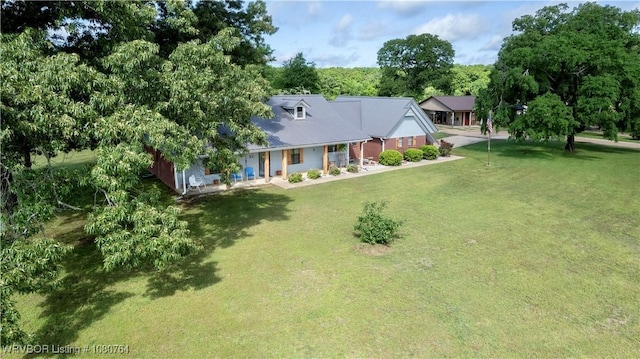 exterior space featuring covered porch and a yard