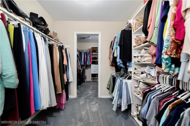 walk in closet featuring dark carpet and visible vents