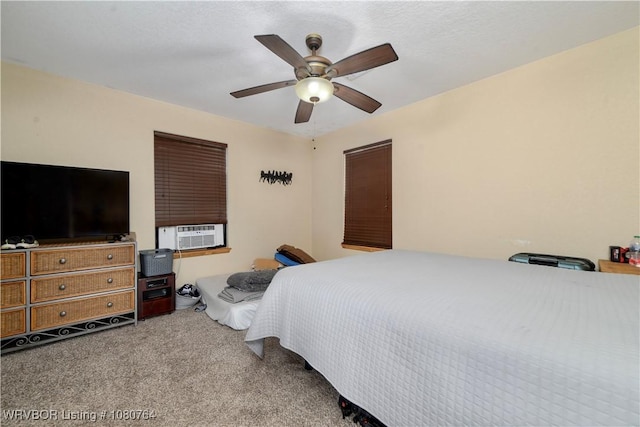 carpeted bedroom with cooling unit and a ceiling fan