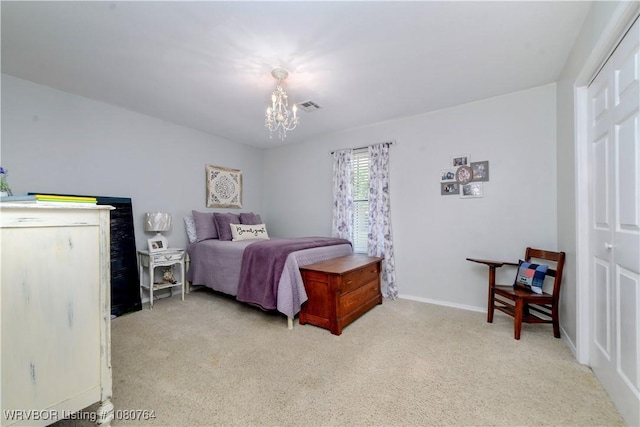 bedroom featuring a chandelier, a closet, visible vents, and carpet floors
