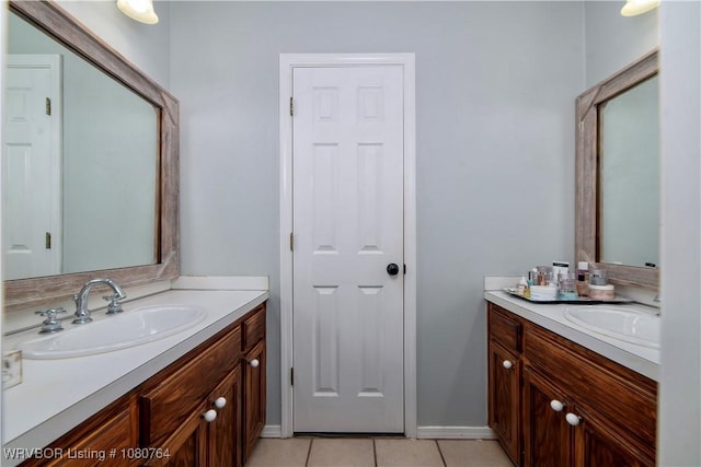 full bathroom featuring tile patterned floors, two vanities, and a sink