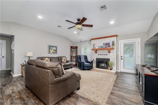 living area featuring dark wood finished floors, a ceiling fan, visible vents, and lofted ceiling