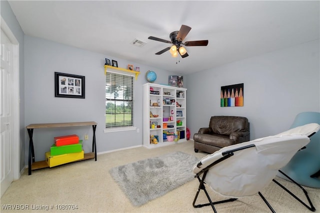 sitting room featuring baseboards, ceiling fan, and visible vents
