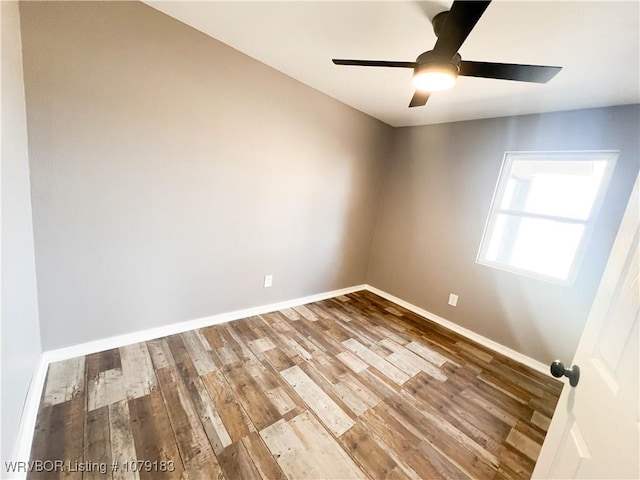 unfurnished room featuring ceiling fan, wood finished floors, and baseboards