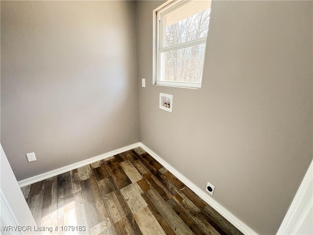 clothes washing area with washer hookup, laundry area, dark wood finished floors, and baseboards