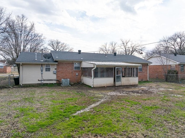 rear view of house featuring cooling unit, a lawn, and a sunroom