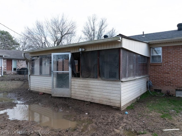 view of side of property with a sunroom