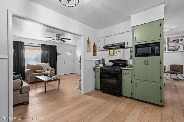 kitchen featuring light hardwood / wood-style floors, green cabinets, and black appliances